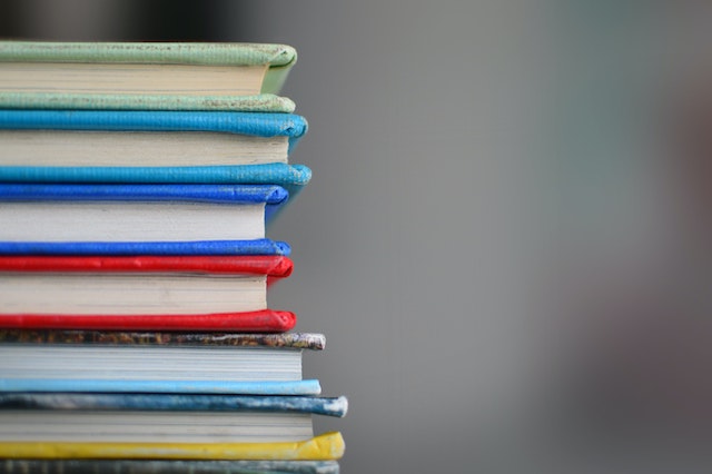 a pile of books on a grey background